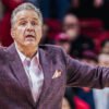 Razorbacks coach John Calipari yells instructions to his team on the floor against Ole Miss