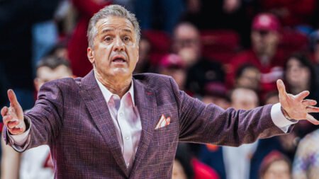 Razorbacks coach John Calipari yells instructions to his team on the floor against Ole Miss