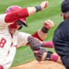 Razorbacks' Cam Kozeal is tagged out at home by South Carolina catcher