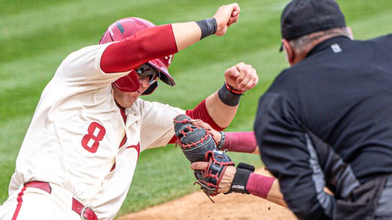Razorbacks' Cam Kozeal is tagged out at home by South Carolina catcher